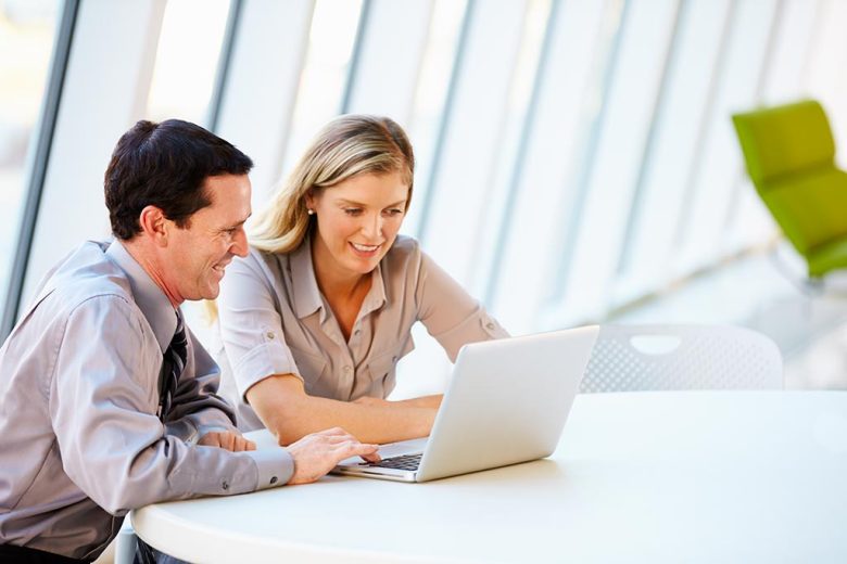 Two people looking at laptop